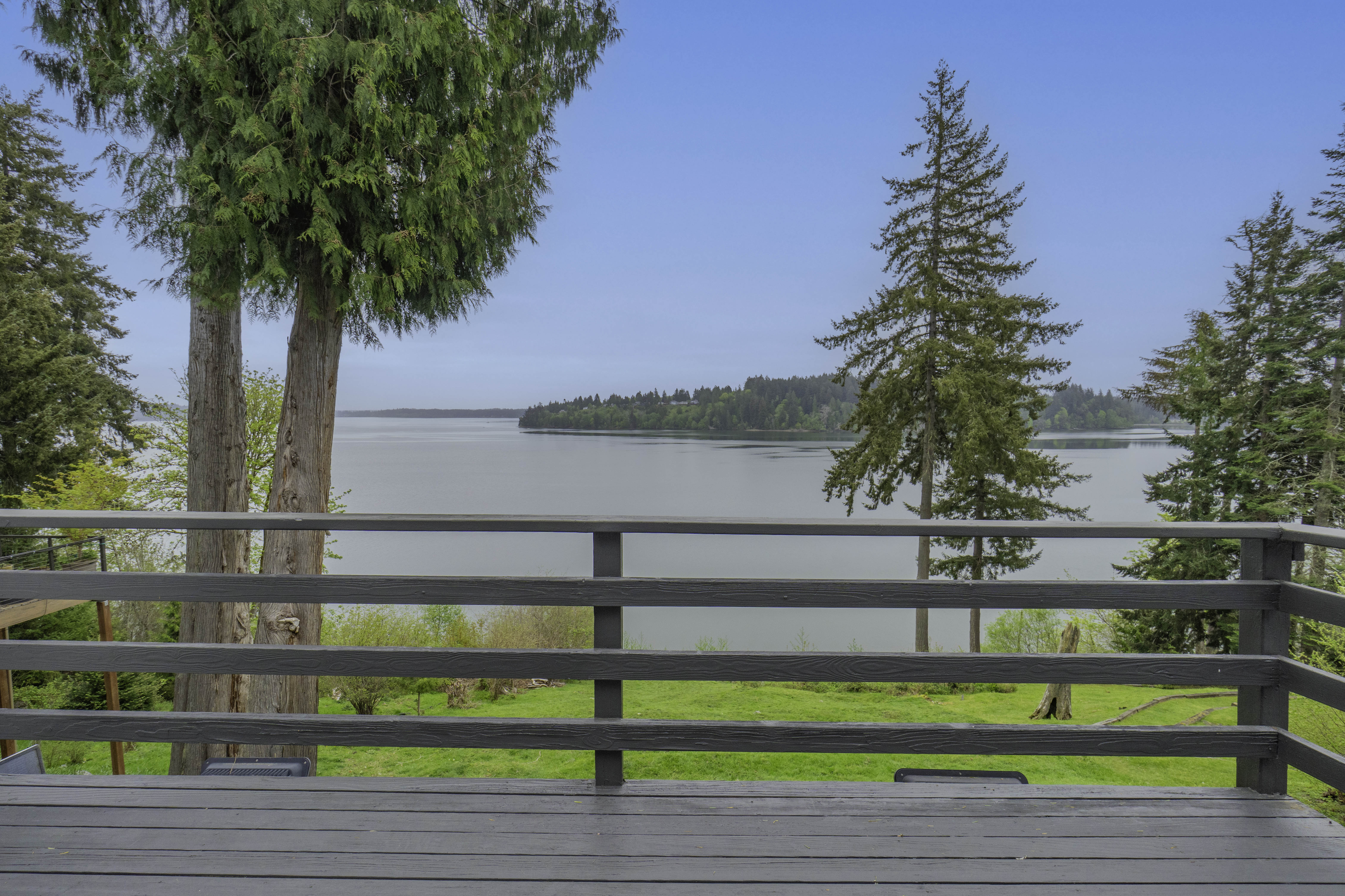 Deck view overlooking Totten Inlet and Pacific Northwest forest