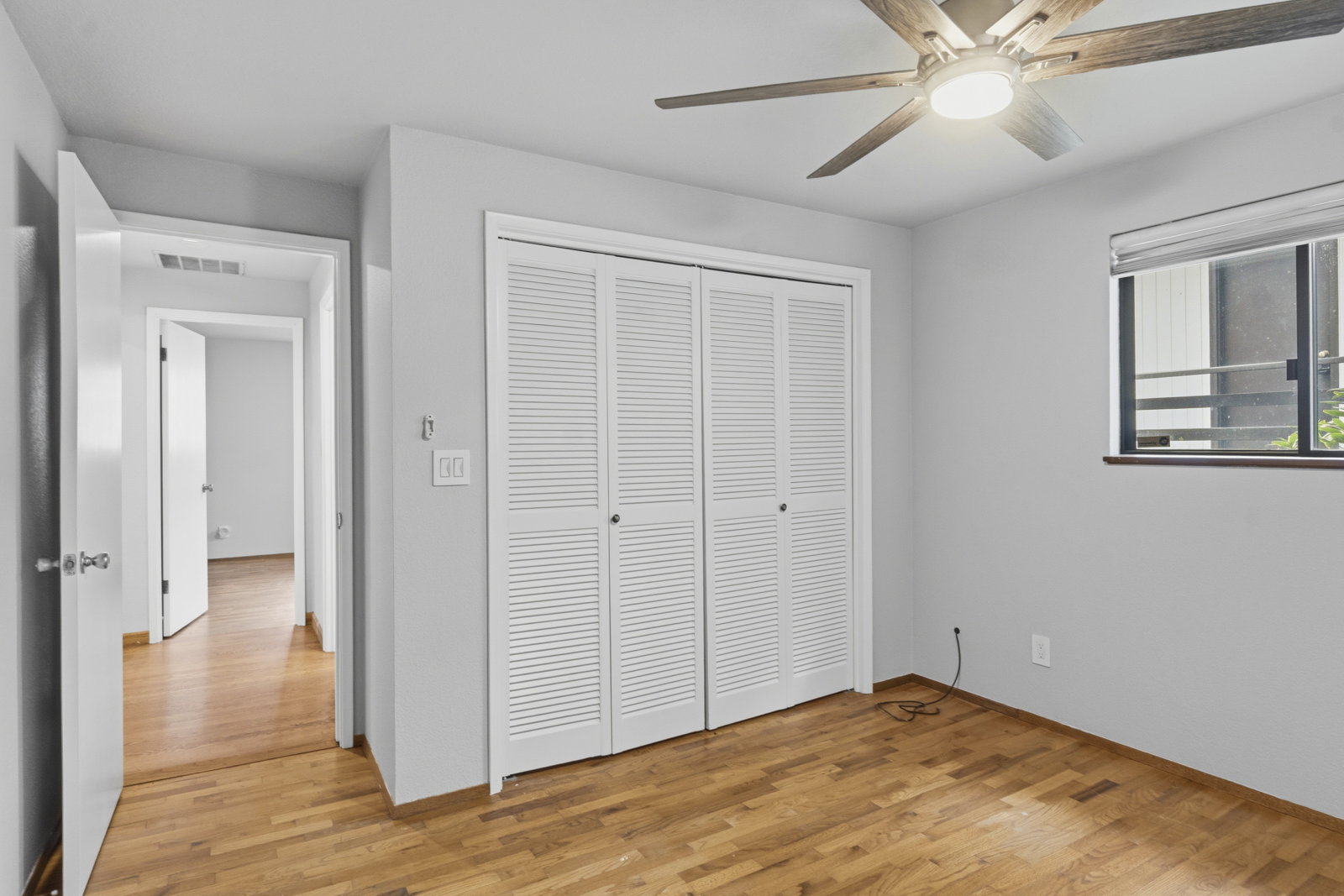 Bedroom with hardwood floors at Shelton waterfront home